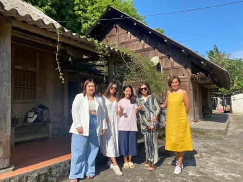 a group of women standing in front of a building at Sa Moc - La Maison House & Bungalow in Sa Pa