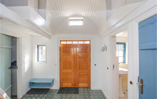 a hallway with a wooden door in a house at Awesome Home In Sams With Kitchen in Brundby