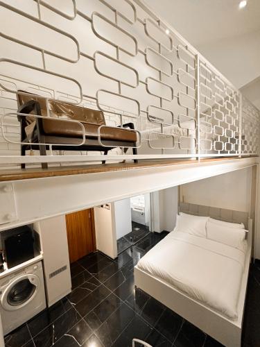 a room with a bed on a shelf at D'Nova Hotel Bugis in Singapore