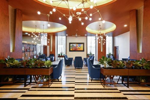 a lobby with chairs and tables in a building at Muong Thanh Grand Saigon Centre Hotel in Ho Chi Minh City