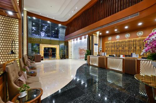 a lobby of a hotel with tables and chairs at Muong Thanh Grand Saigon Centre Hotel in Ho Chi Minh City