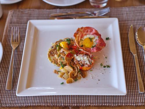a white plate with food on a table at Surana Buffalo Springs in Buffalo Springs  National Reserve