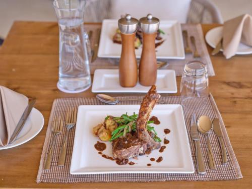 a table with a plate of food on a table at Surana Buffalo Springs in Buffalo Springs  National Reserve
