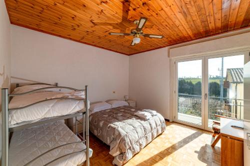 a bedroom with two bunk beds and a ceiling fan at Casa Verdi Colli in Montecastrilli