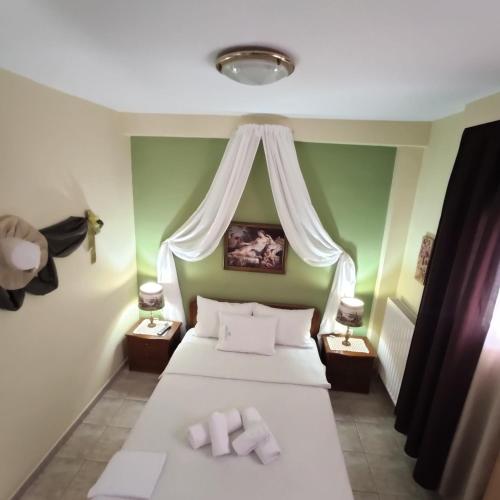 a bedroom with a bed with two towels on it at Giorgos-Vera in Kavála