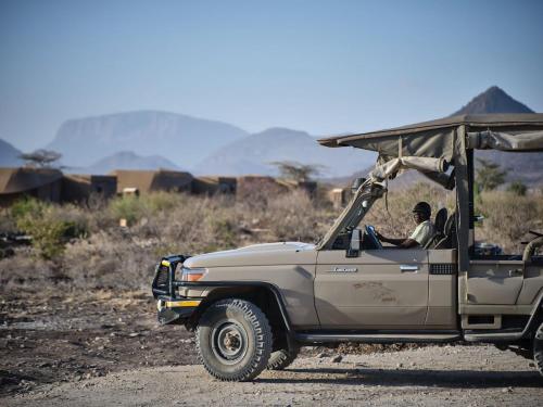 a man driving a jeep on a dirt road at Surana Buffalo Springs in Buffalo Springs  National Reserve
