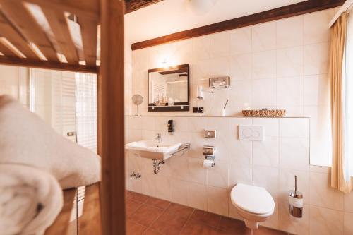 a bathroom with a sink and a toilet at Hotel Einbecker Hof in Einbeck
