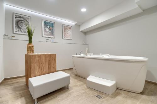 a bathroom with a tub and a sink at Afrodyta Spa in Świnoujście