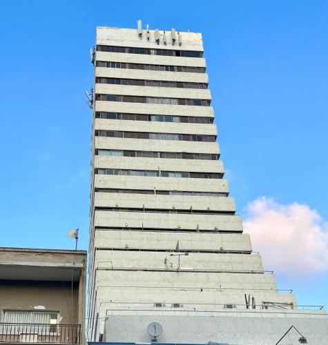 a tall white building with many windows at Haifa Peak in Haifa