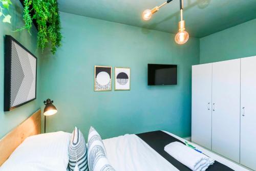 a bedroom with a bed and a green wall at LikeHome Jerusalem in Jerusalem