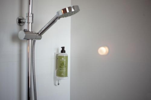 a shower with a soap dispenser in a bathroom at Hotel Saint Louis in Brest