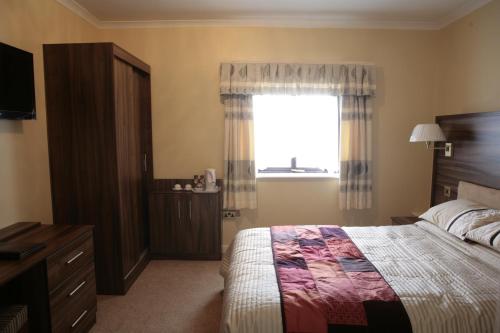 a bedroom with a bed and a window at The Plough Inn in Pocklington
