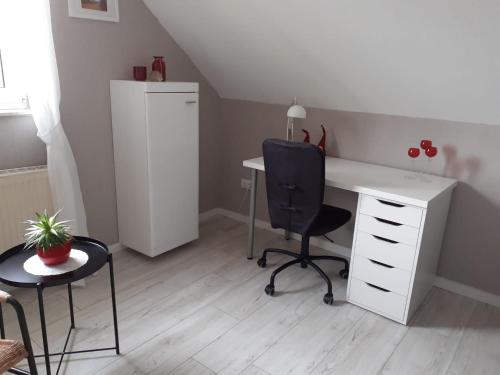 an office with a desk and a chair and a desk and a chair at Haus Mühlenbach in Mechernich