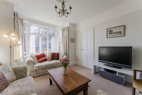 a living room with a couch and a tv at 9 Morris Street in Sheringham