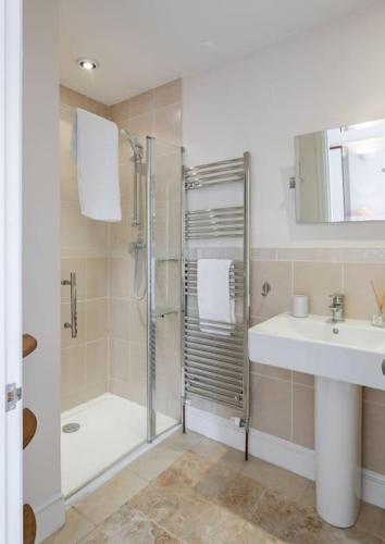 a bathroom with a shower and a sink at 9 Morris Street in Sheringham