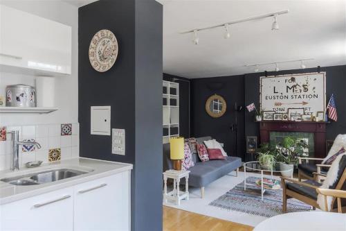 two pictures of a kitchen and a living room at Stylish flat next to King's Cross Station in London