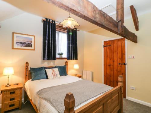 a bedroom with a large bed in a room at The Hawthorns in South Molton