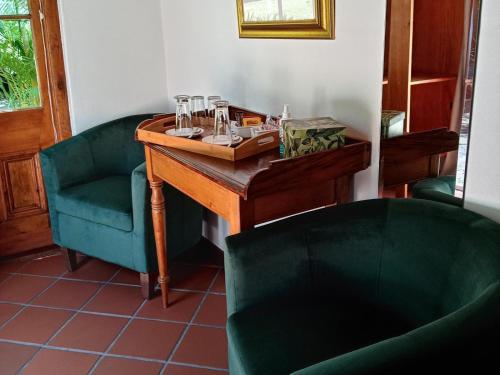 a table and two chairs in a room at The Oil Mill Guesthouse in Swellendam