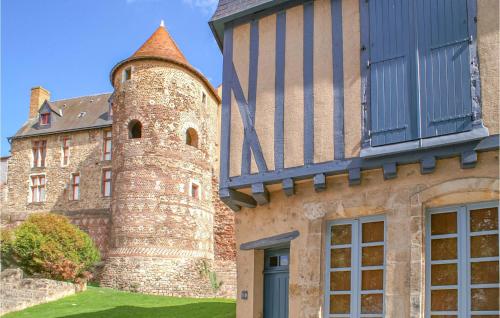 an old castle with a tower next to a building at Nice Home In Conflans Sur Anille in Conflans-sur-Anille