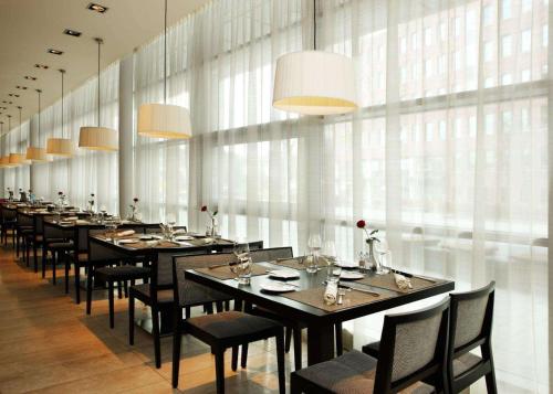 a long dining room with long tables and chairs at NH Amersfoort in Amersfoort