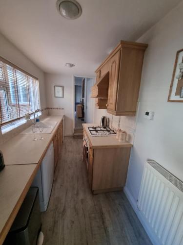 a kitchen with a sink and a stove top oven at Cottage 5 minutes walk to river and town centre in Stratford-upon-Avon