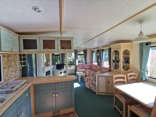 a kitchen and living room of a caravan at Secluded Farmland Retreat - Valley View in Totnes