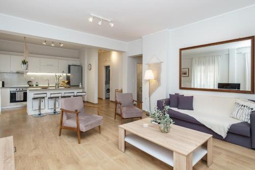 a living room with a couch and a table at Cataleya #colony city center in Thessaloniki