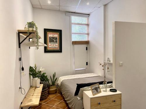 a bedroom with a bed and a table and a mirror at Apartamento Puerta del Camino 1 in Bilbao