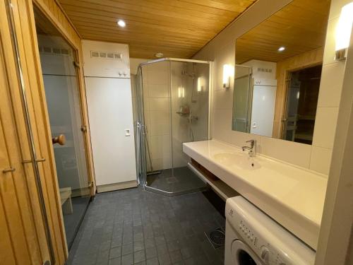 a bathroom with a shower and a sink at Vuokatti Chalets Aarni in Vuokatti