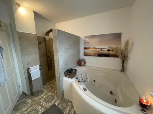 a bathroom with a large white tub in a room at Ferienwohnung Fenke in Fenke