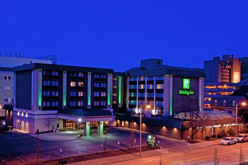 a building with a parking lot in a city at night at Holiday Inn Johnstown-Downtown, an IHG Hotel in Johnstown