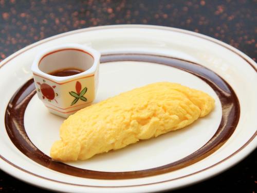 a plate with a pastry and a cup of coffee at Kishigon Ryokan in Shibukawa