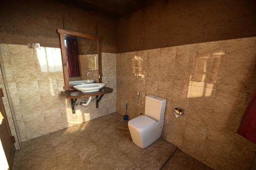 a bathroom with a toilet and a sink at Ella Camelot in Ella