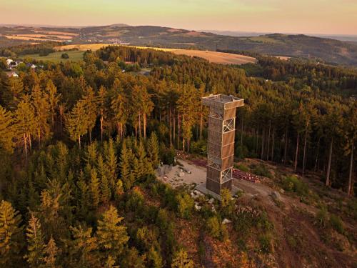 an aerial view of a tower in a forest at Apart Hotel Jablonec in Jablonec nad Nisou