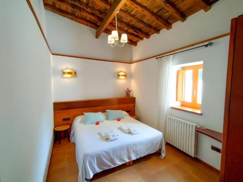 a bedroom with a white bed and a window at Es Pas Formentera Agroturismo in Es Calo