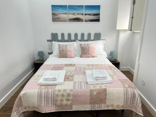 a bedroom with a large bed with two plates on it at Casa da Ladeira - Figueira da Foz in Figueira da Foz