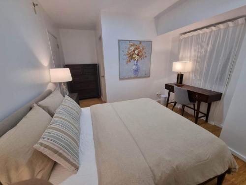 a bedroom with a bed and a desk in it at Casa de Rosand in Cebu City