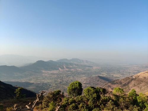 a view of a valley from a mountain at Hilltop Resort and Glamping Wai, Near Panchgani in Wai