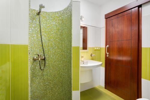 a bathroom with a shower and a sink at Casita Paraiso in Los Quemados