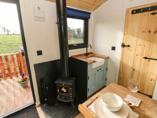 a kitchen with a stove in a tiny house at The Bumblebee in Pembroke