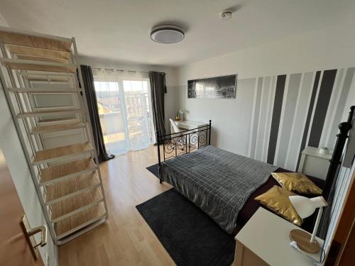 a bedroom with a bed and a book shelf at KnocksCasa4You 3 Zimmer Wohnung Nr.23 Marburg in Marburg an der Lahn