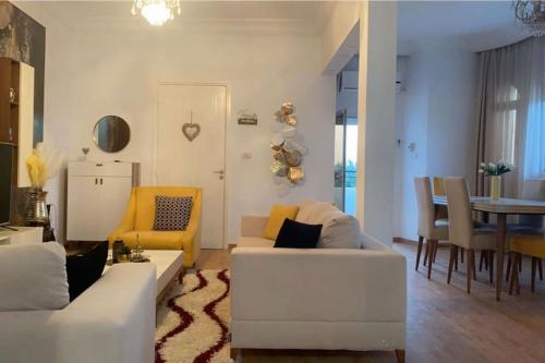 a living room with a white couch and a dining room at Outstanding Two bedroom Apartment in Sahline