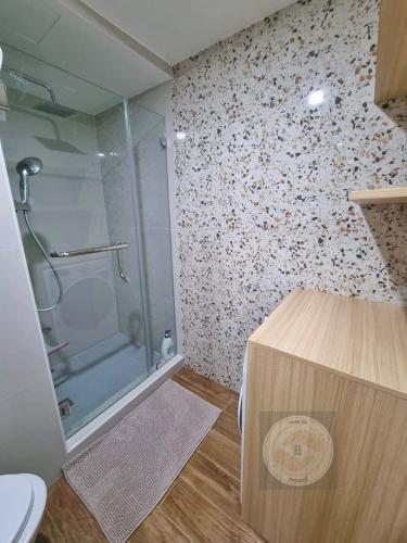 a bathroom with a shower and a toilet at Casa de Rosand in Cebu City