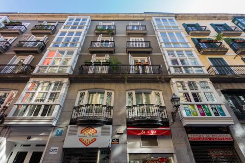 a tall building with balconies on a city street at Casual Arriaga in Bilbao
