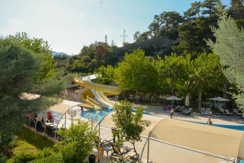 a resort with a pool and a slide at MIRAMOR HOTEL & Spa - ULTRA ALL INCLUSIVE SELECTION in Kemer