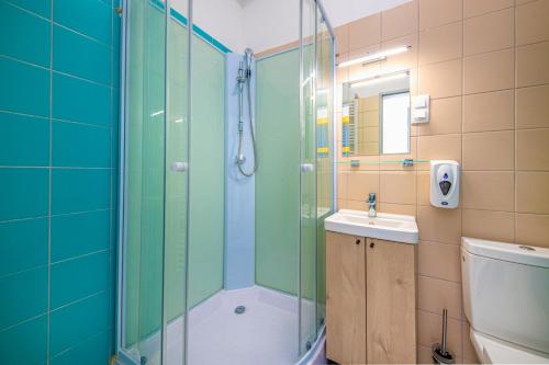a bathroom with a shower and a sink at Zsóry Liget Panzió in Mezőkövesd