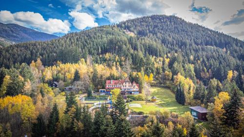 a large house in the middle of a mountain at Hotel Sluníčko in Ostravice