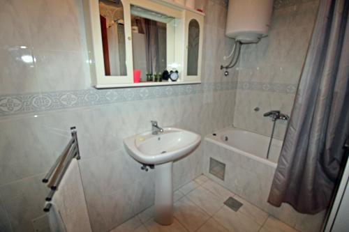 a bathroom with a sink and a bath tub at Apartment Branka in Premantura
