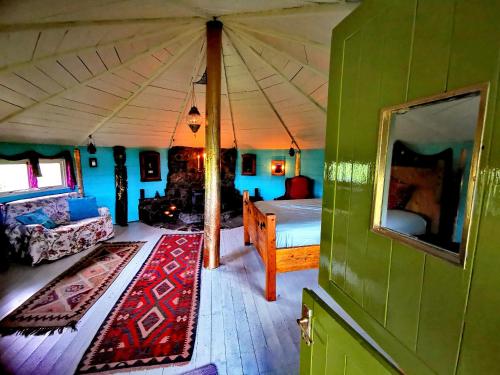 a room with a bed in a tent at The Round House in Newton Stewart