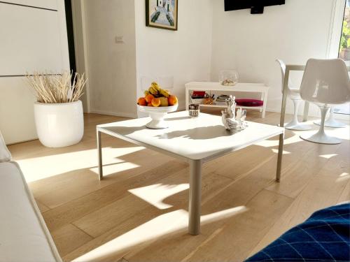 a living room with a white table with fruit on it at House Casbah Porto Rotondo in Porto Rotondo